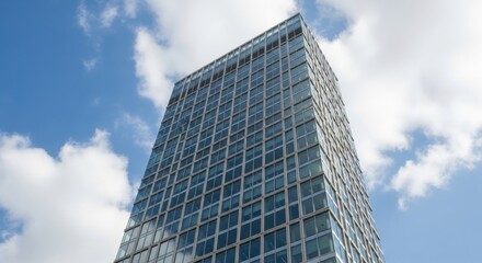 Obraz premium Modern Glass Skyscraper Against Blue Sky