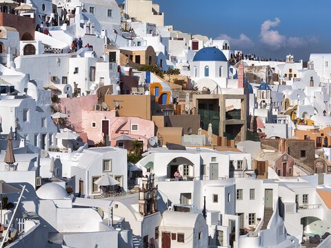 White and colorful painted houses on a steep slope, Oia, Santorini, Cyclades, Greece