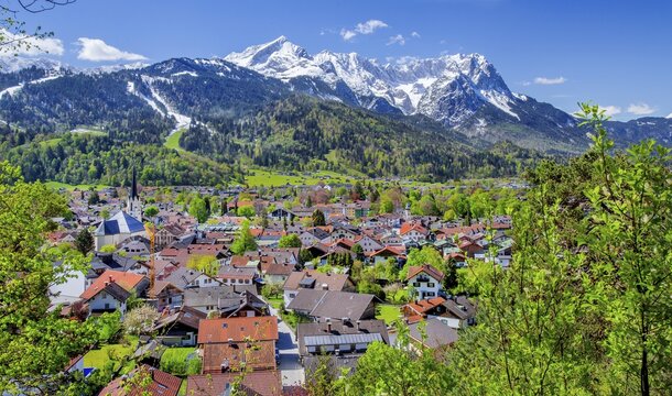 View of the village in spring with the Partenkirchen parish church in front of the Zugspitze group 2962m in the Wetterstein Mountains, Garmisch-Partenkirchen, Loisach Valley, Werdenfelser Land, Bavarian Alps, Upper Bavaria, Bavaria, Germany