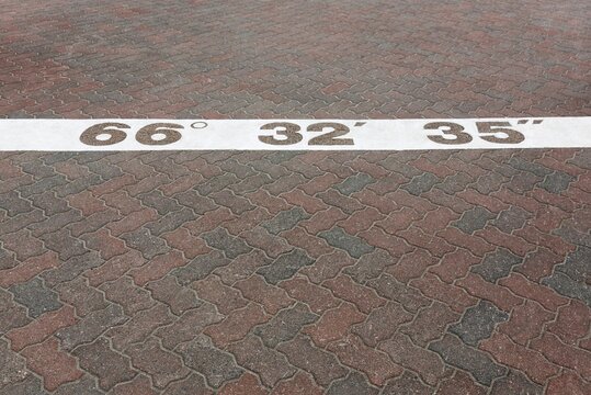 Arctic Circle marking with coordinates, Santa Claus Village, Rovaniemi, Lapland, Finland