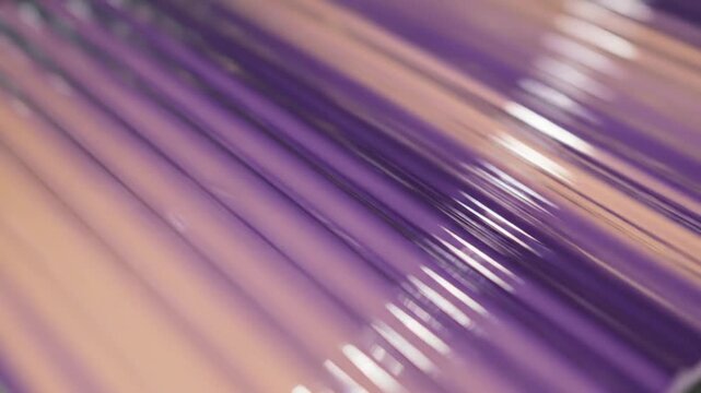 Abstract purple and rose gold glossy diagonal liquid ripples