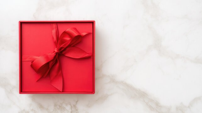 formal. Elegant red gift box tied with a satin ribbon, placed on a sleek marble surface. lifestyle magazines, social media lookbooks, designed for influencer and brand collaborations.