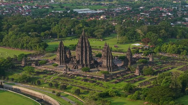 Aerial view of the ancient Prambanan Temple complex with tall stone spires and lush green parkland in Kecamatan Prambanan, Daerah Istimewa Yogyakarta, Indonesia.