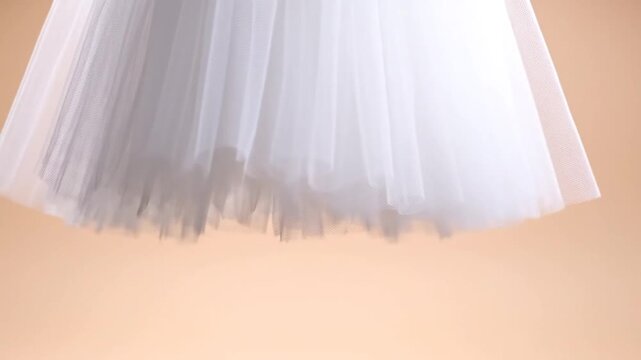 Close-up of white pleated tulle fabric skirt detail.