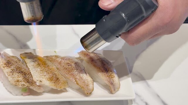Chef Searing Fresh Nigiri Sushi with a Blowtorch in Kanazawa Japan