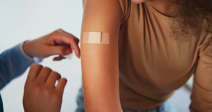 Hands, child and plaster for vaccine with nurse for medicine, flu shot and healthcare at clinic. Kid, bandage and cover for injection, help and boost for immune system, virus or bacteria at hospital