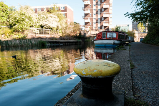 Yellow mooring bollard on regent's canal in london