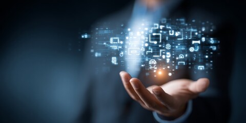 Fototapeta premium Businessman Presenting Software Development Concept with Coding Symbols and Technology Icons Floating Above His Hand Against a Dark Background