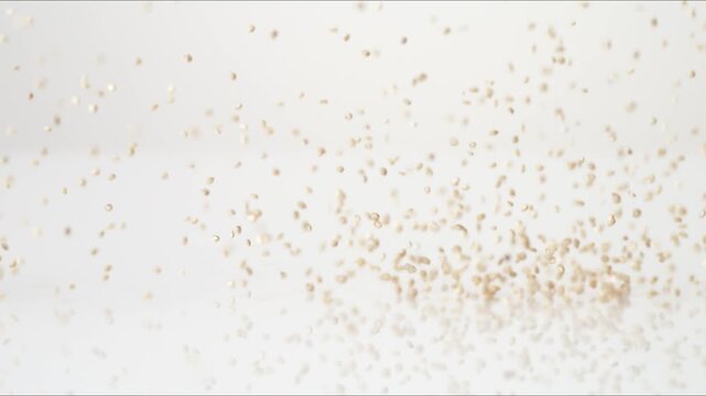 Plant protein superfood Quinoa bouncing on a white tabletop in slow motion close up macro before settling.