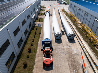 Giant wind turbine blades parked in factory yard for transport © zhu difeng
