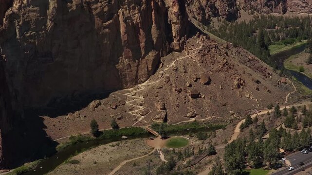 Aerial of Smith Rock State Park Misery Ridge hiking trail with zig zag switchbacks in Redmond Oregon on sunny spring day