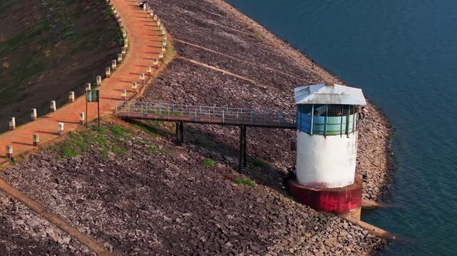 Close up shot of watch tower with pathway, water and tourist at Chiklihole Reservoir, Coorg, Madikeri, karnataka, india. day time, semi orbit shot, drone shot, 4k.