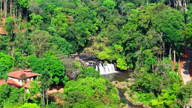 Kote Abbey Waterfalls with forest, road and independent house at mukkodlu, coorg, Madikeri, karnataka, india. day time, push back shot, drone shot, 4k.