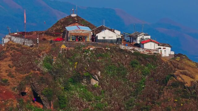 Close up shot of Mullappa Swami Temple with caves and Mullayanagiri peak at Western Ghats, Chikkamagaluru, karnataka, india. day time, push back shot, drone shot, 4k.
