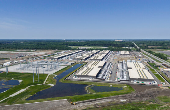 Aerial view of the construction of data center complex, large AI center structure surrounded by cooling and power back up systems