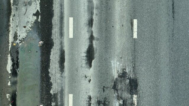 A cracks, potholes, and erosion, pointing to underfunded repairs, transport risks, ineffective management, environmental stress, infrastructure aging, and a pressing need for sustainable solutions.
