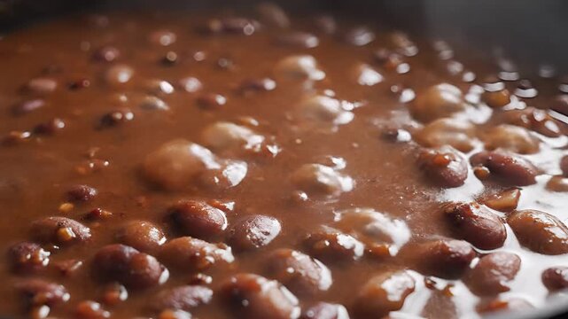 Closeup of Red Beans Simmering in a Rich Brown Sauce.