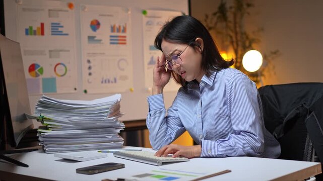 Overworked asian businesswoman feeling stressed at night office