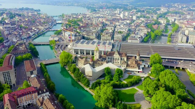 Zurich, Switzerland. Swiss National Museum and Zurich Main Station, aerial panoramic view over the Limmat river and city center on a clear summer day. Drone footage, Point of interest
