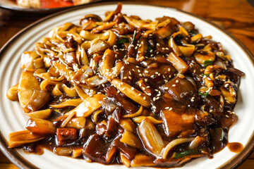 Fototapeta premium A large sharing platter of Jaengban Jjajang, featuring delicious noodles stir-fried together with rich black bean sauce, pork, and seafood.