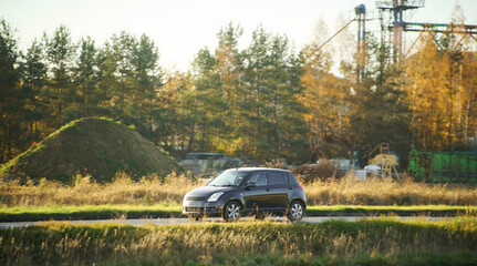 Fototapeta premium Small vehicle on sunny rural road
