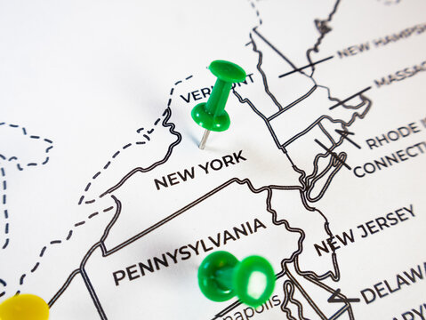 Macro close-up of a Northeast US map with a prominent green push pin marking New York. Perfect concept for regional business targeting, logistics, demographics, and travel planning.