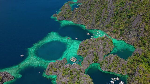Aerial ascending forward movement shot over limestone karsts and Twin Lagoon in Coron, Palawan, Philippines