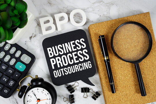 BPO - Business Process Outsourcing acronym with calculator, alarm clock and magnifying glass, business concept background