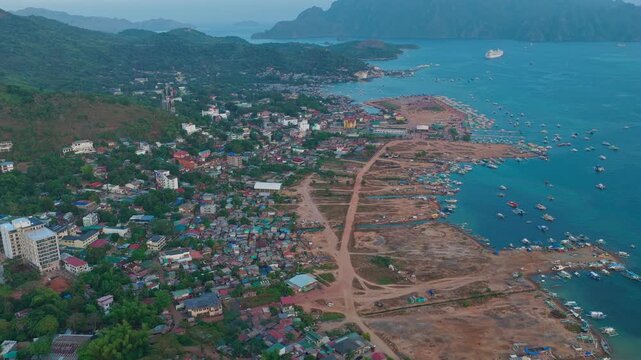 Aerial straight forward shot of Coron town coastal landscape and harbor in Palawan, Philippines.