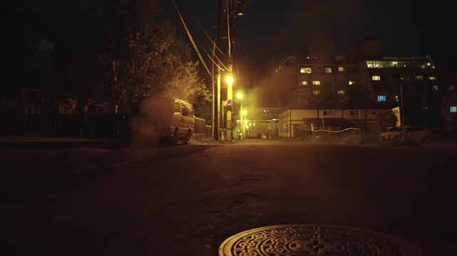 Steam rising from streets in the night, Onsen Hot Spring Town, Jozankei Japan