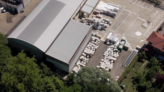 Top-down drone footage of an industrial plant producing refractory materials. Facility focused on manufacturing heat-resistant and insulation materials for construction and heavy industry.