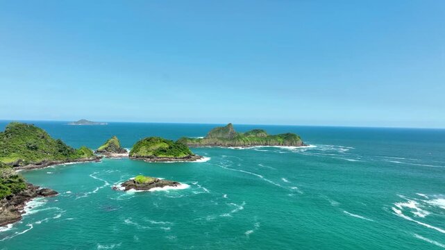 Aerial Dolly In of Green Island Tropical Rock Formations Indonesia East Java landscape