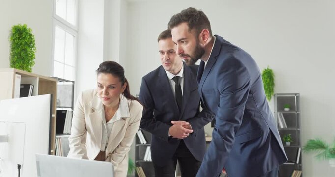 Business team meeting in office planning strategy project. Managers and colleagues analyze data on a monitor and align next steps in a modern workspace. Strong teamwork and strategy concept.