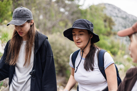 Young women friends hiking together on a trail