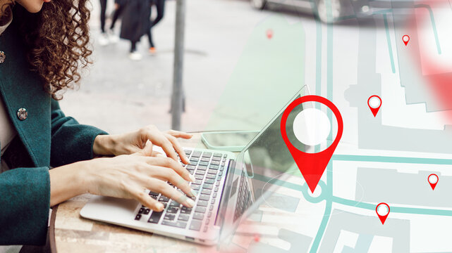 Person using laptop to find taxi route on map in city street during daytime