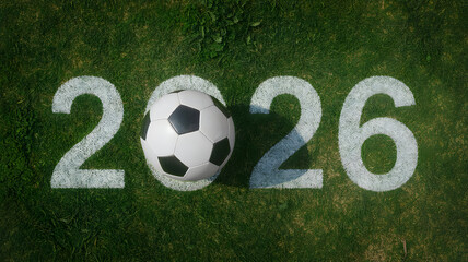 Obraz premium Soccer ball on a green field with 2026 painted numbers