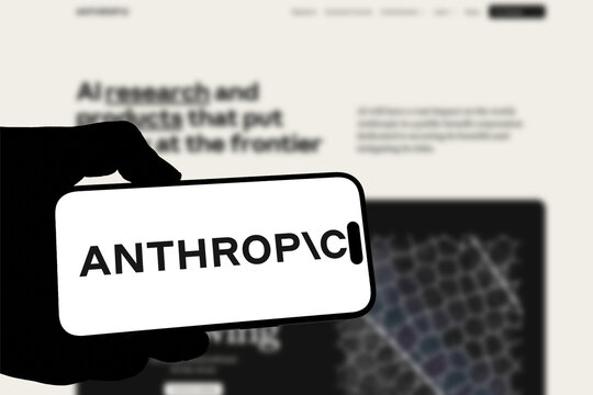 Kiel, Germany - 05-20-2026: Smartphone displaying the US AI research company Anthropic app in the App Store in a workspace environment with laptop and notebook