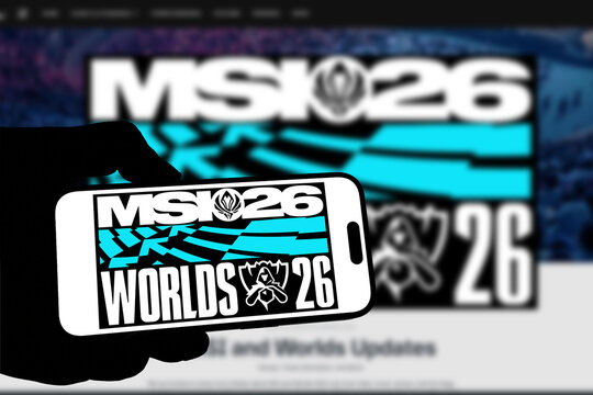 Kiel, Germany - 05-20-2026: Smartphone displaying the international esports tournament League of Legends MSI 26 app in the App Store in a workspace environment with laptop and notebook