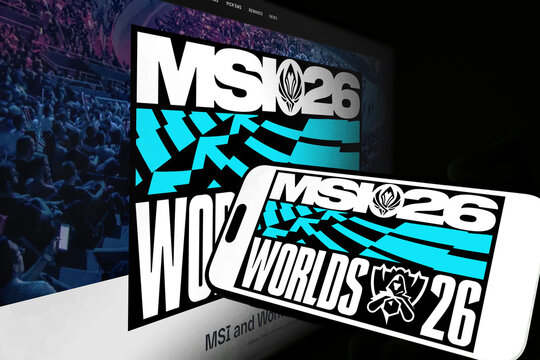 Kiel, Germany - 05-20-2026: Smartphone displaying the international esports tournament League of Legends MSI 26 app in the App Store in a workspace environment with laptop and notebook