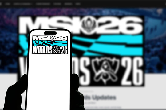 Kiel, Germany - 05-20-2026: Smartphone displaying the international esports tournament League of Legends MSI 26 app in the App Store in a workspace environment with laptop and notebook