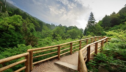 Fototapeta premium Beautiful Timber Railings Along Scenic Mountain Path Surrounded By Lush Greenery