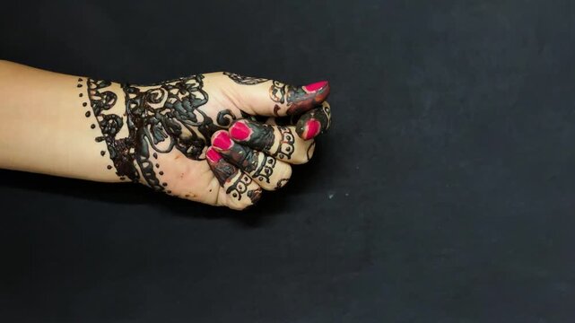 bridal mehendi pattern with elegant black henna artwork on fingers and palm