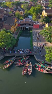Aerial view of Chua Cau or Japanese Covered ancient Bridge and River in Old city of Hoi An, Vietnam. One of the most travel popular touristic destinations, UNESCO world heritage 