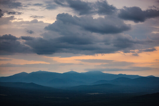 Dramatic stormy sunset over a hazy blue mountain range