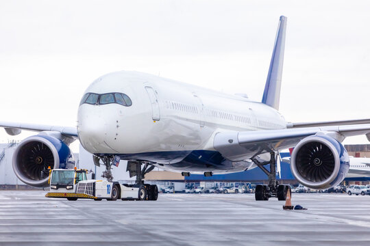 Airport tug moving a modern wide body jet