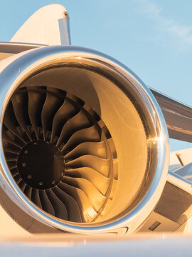 Private jet engine glowing in golden hour light