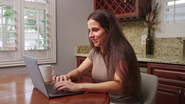 Woman happy as she responds to email