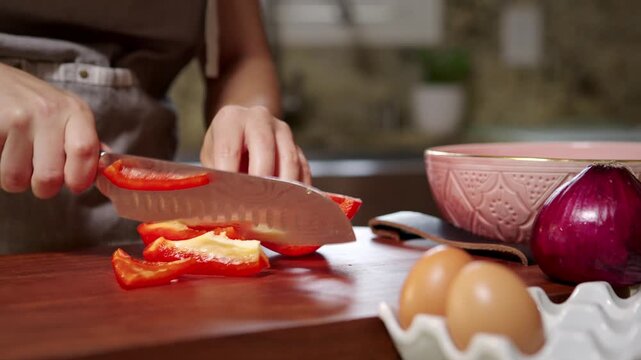 Woman prepares vegetables for making an omelette