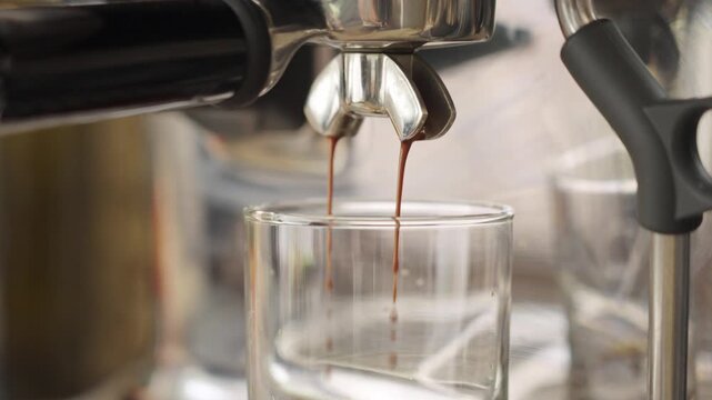 pouring a double shot of espresso into glass, slow motion