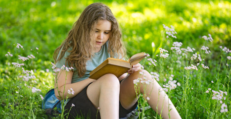Naklejka premium Child school reading supports young education. Peaceful child enjoys school reading outdoors. Smart student practices child school reading. Summer park inspires focused school reading.